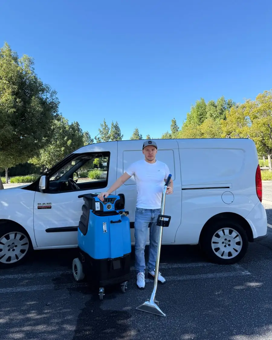 The Pico Steamers owner beside the van with the carpet extractor and cleaning wand